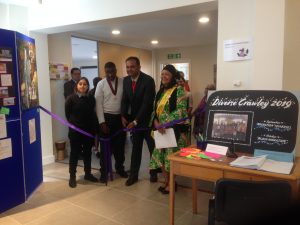 People waiting to cut the ribbon to open the migration exhibition