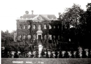 Photograph of Crabbet House, fron view, covered in ivy