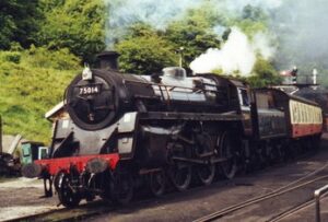 Black locomative in steam, pulling red and cream carriages.