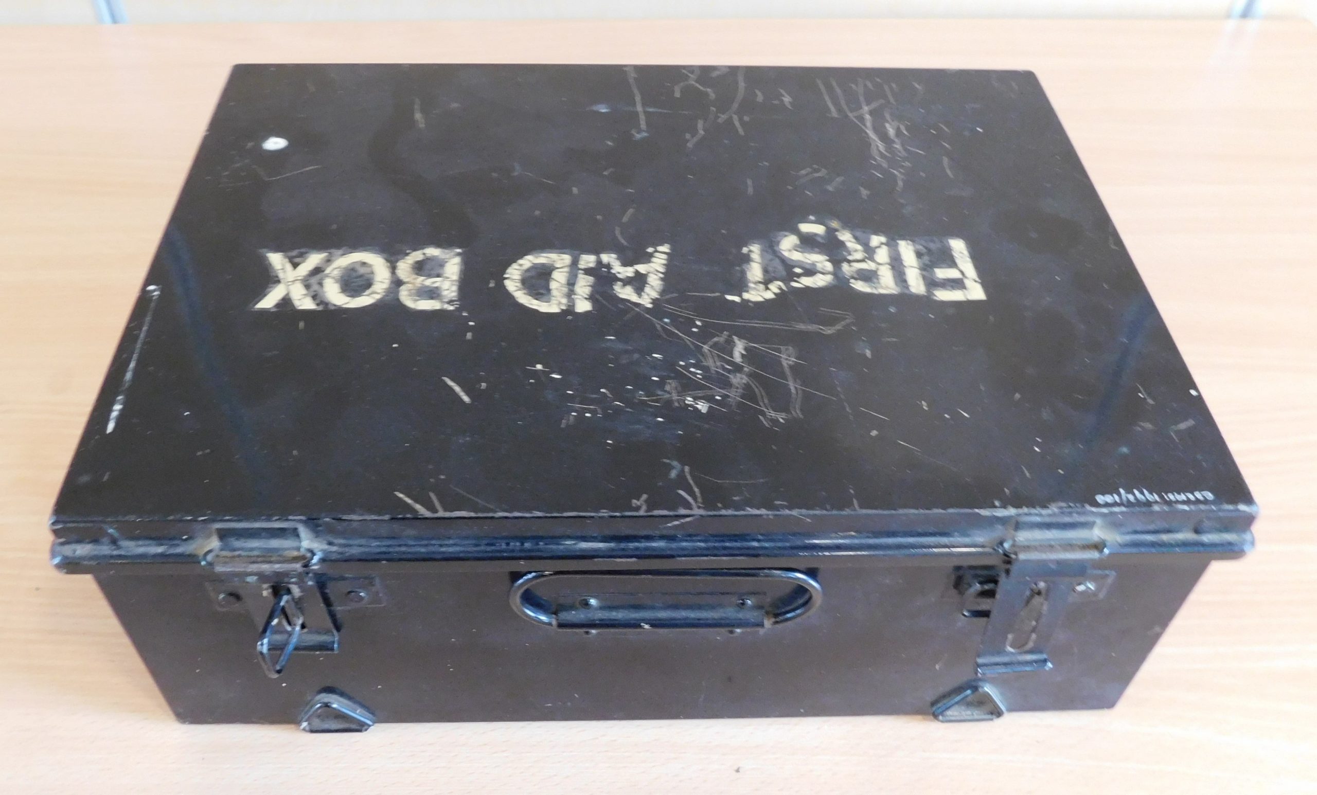 Black metal box with words 'First Aid Box' in white on the lid.