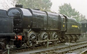 dark green locomotive on tracks. Yellow writing on side reads 'Southern'.