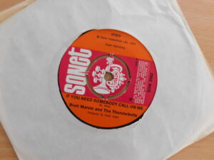 7" vinyl record in white sleeve. record is 'If you need somebody call on me' by Brett Marvin and the Thunderbolts.