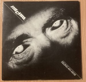 Record Sleeve. Close up of eyes, with words 'The Cure. Killing An Arab'