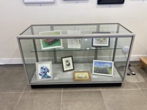 Display case with art works in.