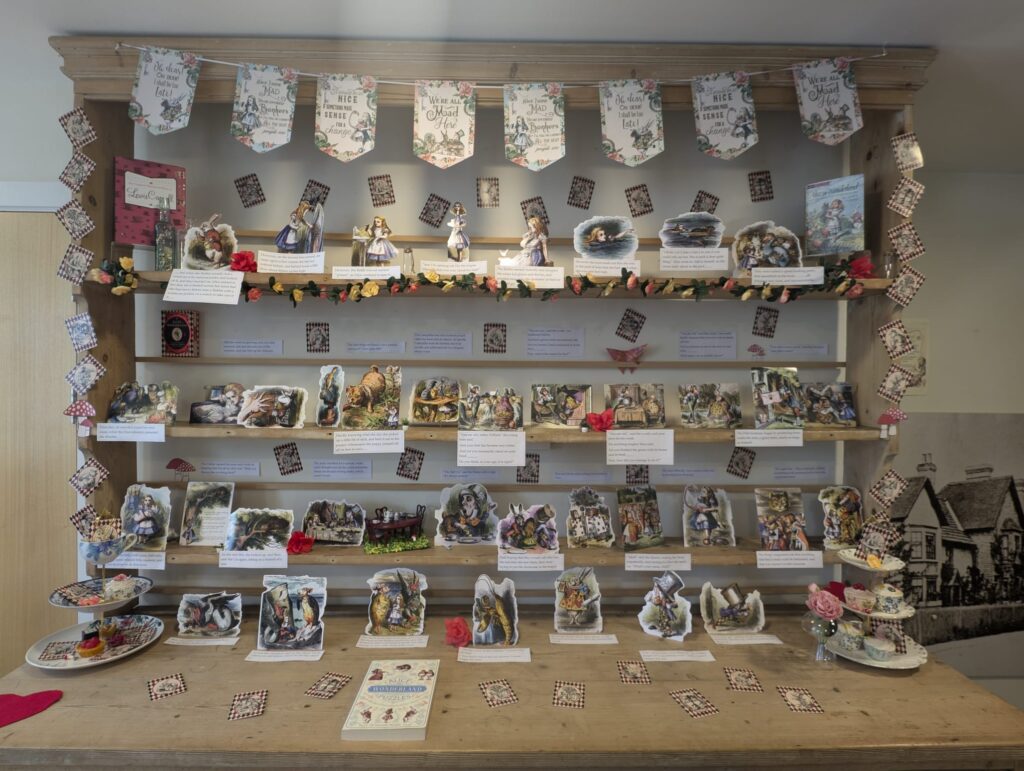 Wooden shelf with pieces of paper attached to the front. 