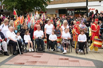 Group of people sitting and standing outside. 