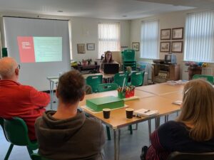 A group are looking at a presentation on a screen